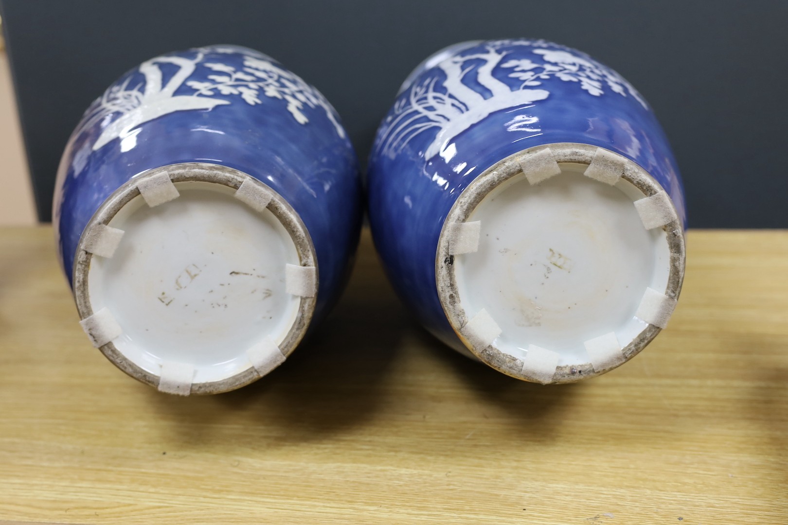 A pair of large 19th century Chinese slip decorated blue ground vases, restored, 59cm